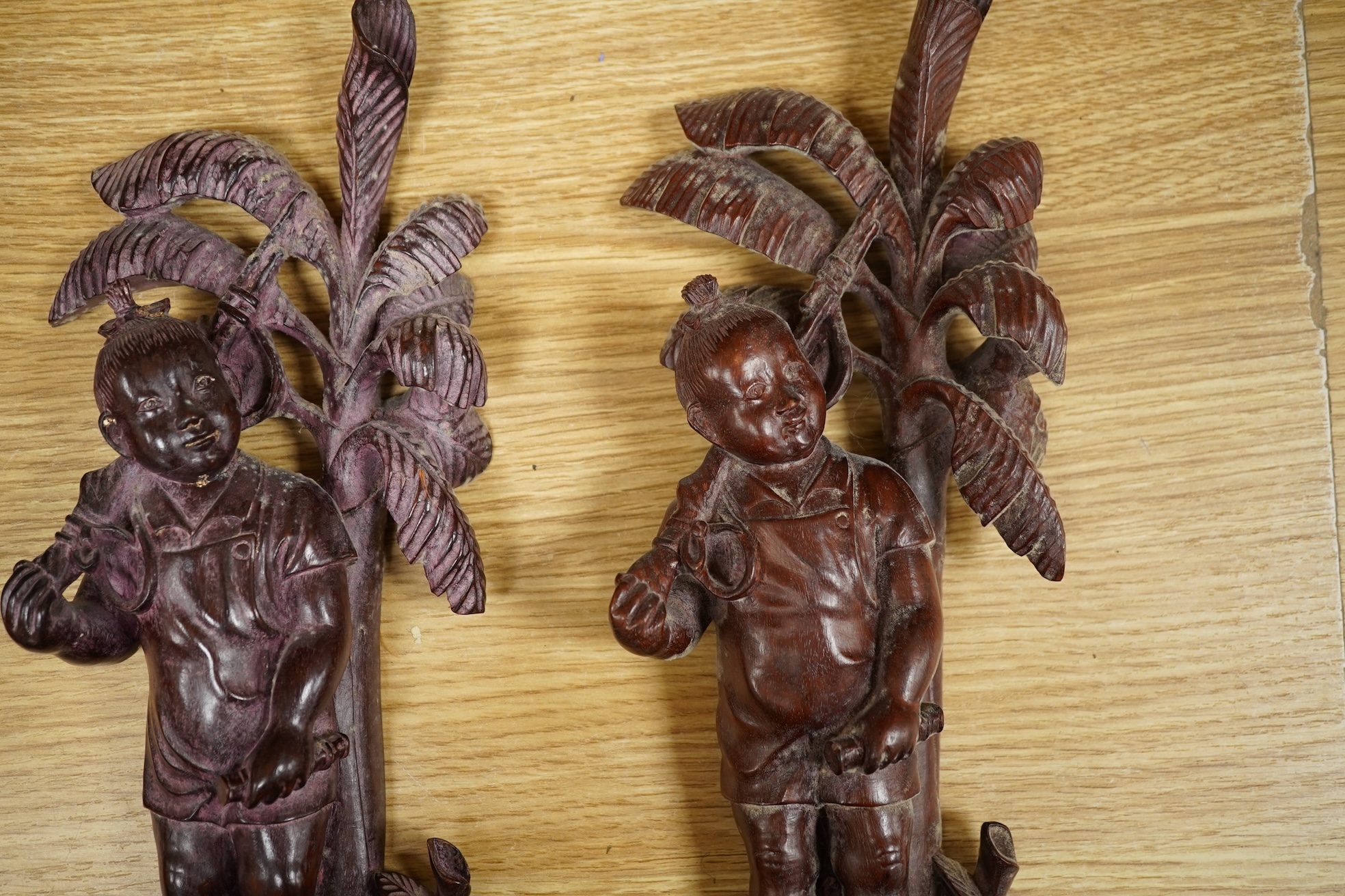 Four 1960's Chinese Cultural Revolution figures of boys holding a rifle, 33cm high